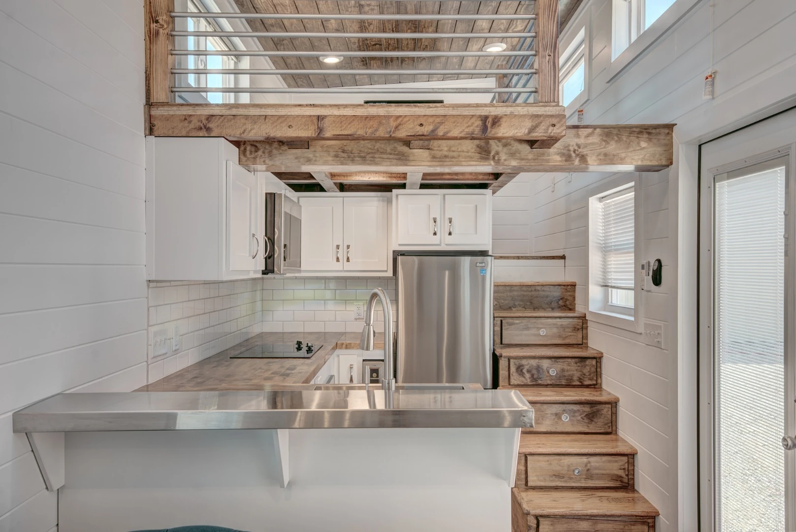 Lofts have become an almost essential component of tiny house living, but few offer the headroom of the recently completed Journey by Alabama Tiny Homes