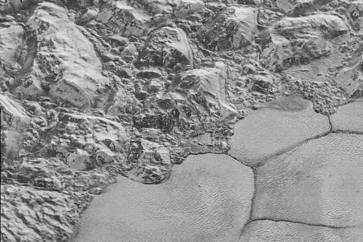 Great chunks of Pluto’s water-ice crust appear jammed together in the al-Idrisi mountains