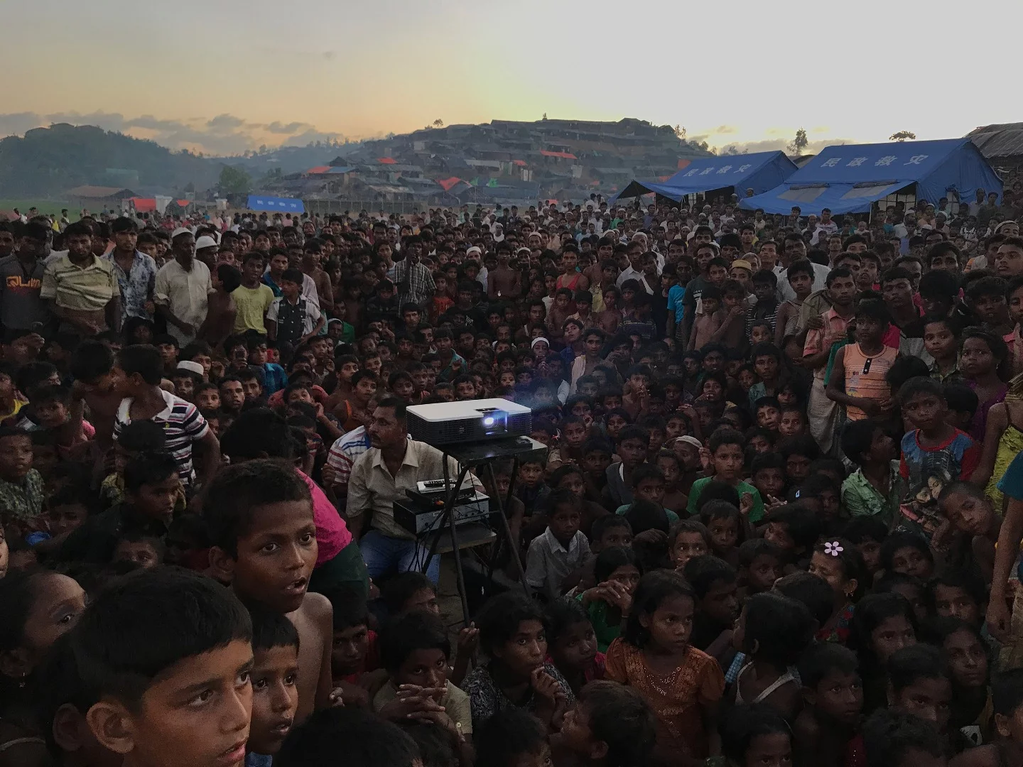 The Grand Prize winner of the 2018 iPhone Photography Awards shows a group of Rohingyan children watching an awareness film about health and sanitation near a refugee camp outside Ukhiya, Bangladesh