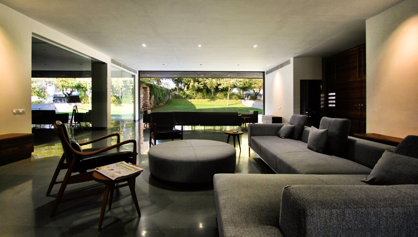 Private Residence No. 7's living room opens up to the garden with sliding glass doors