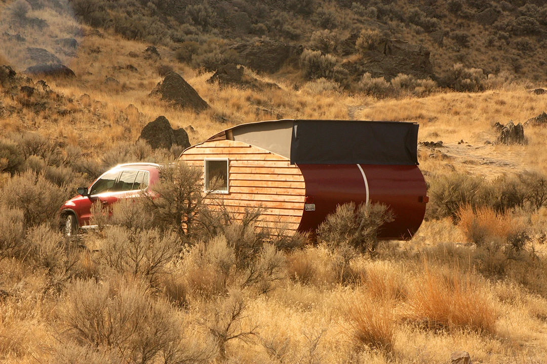 The trailer features a simple pop-top roof section to allow additional headroom