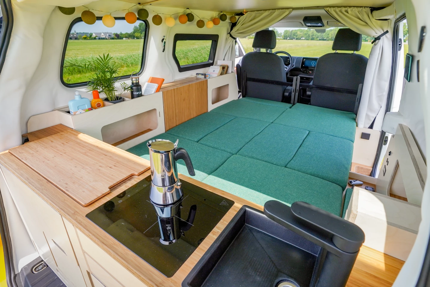 To fit the central double bed in the short ID. Buzz van, Ventje relies on sliding the front seats forward for the extra room it needs