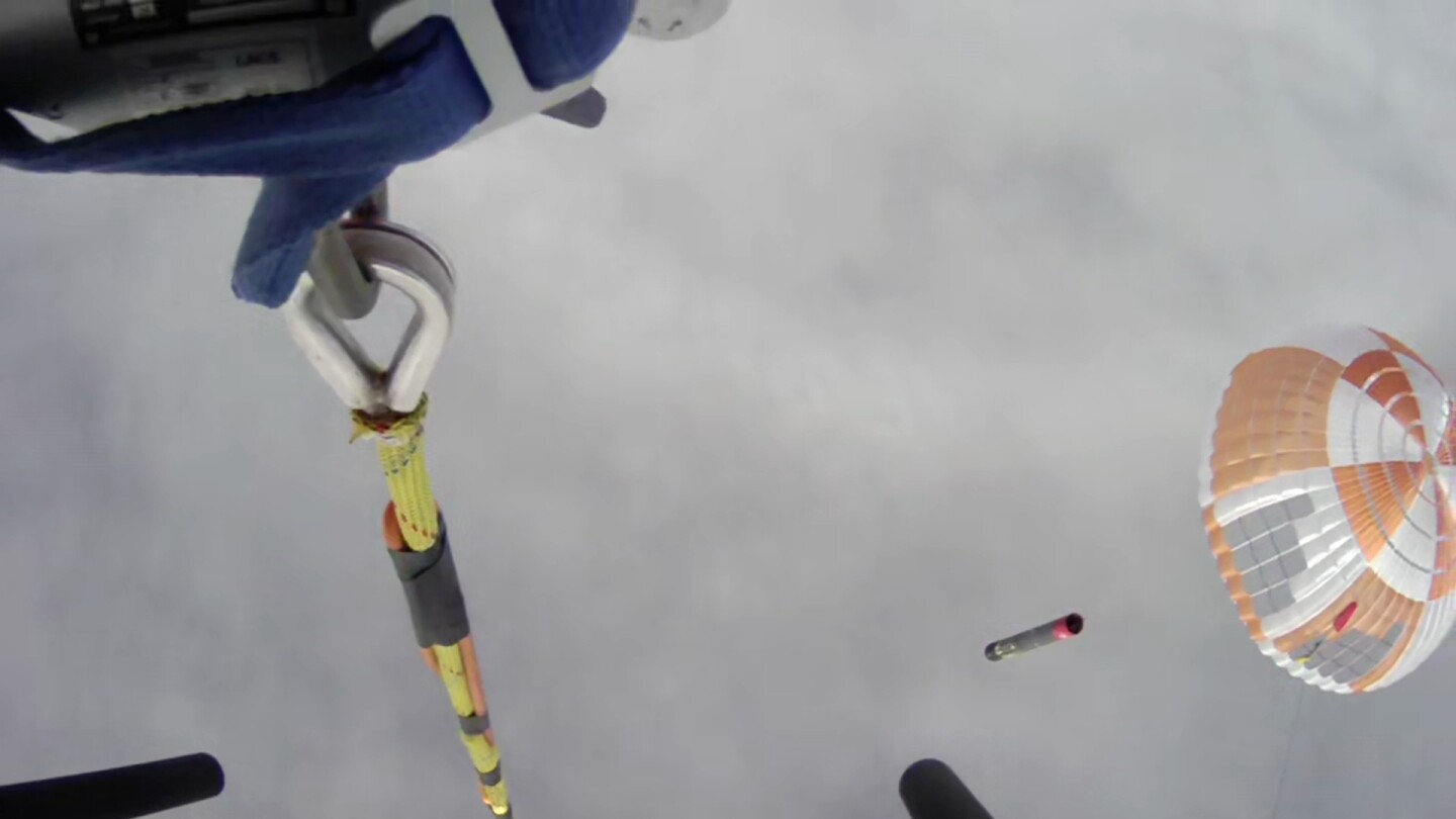 View from Rocket Lab's chopper as it prepares to capture the Electron booster and parachute