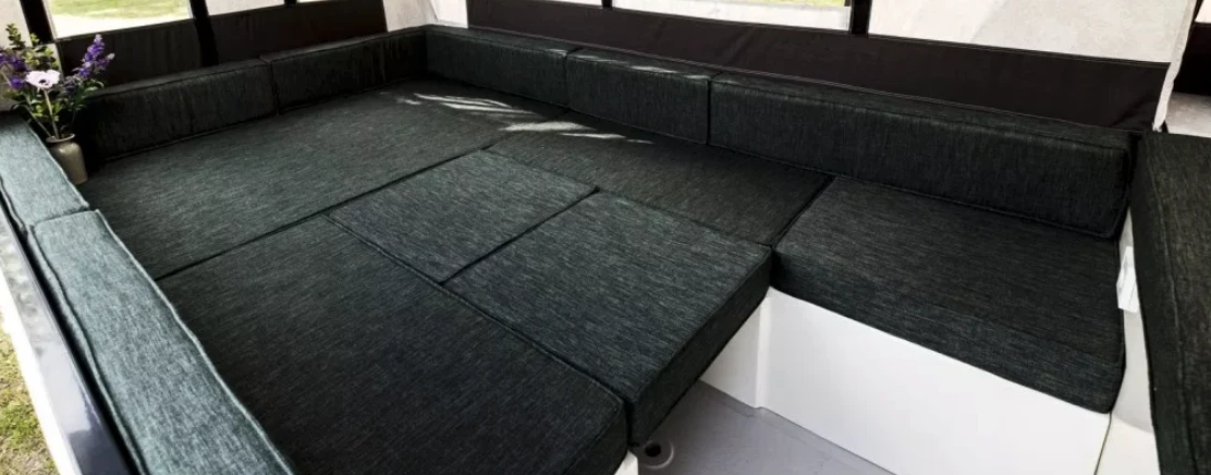 The dining table drops down to support the cushions that fill out the main bed