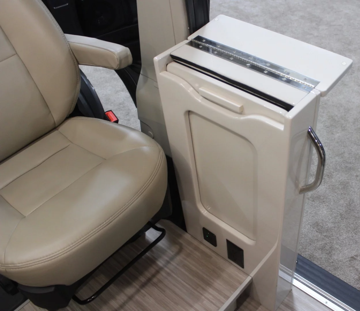 The passenger seat includes a fold-out work/dining table