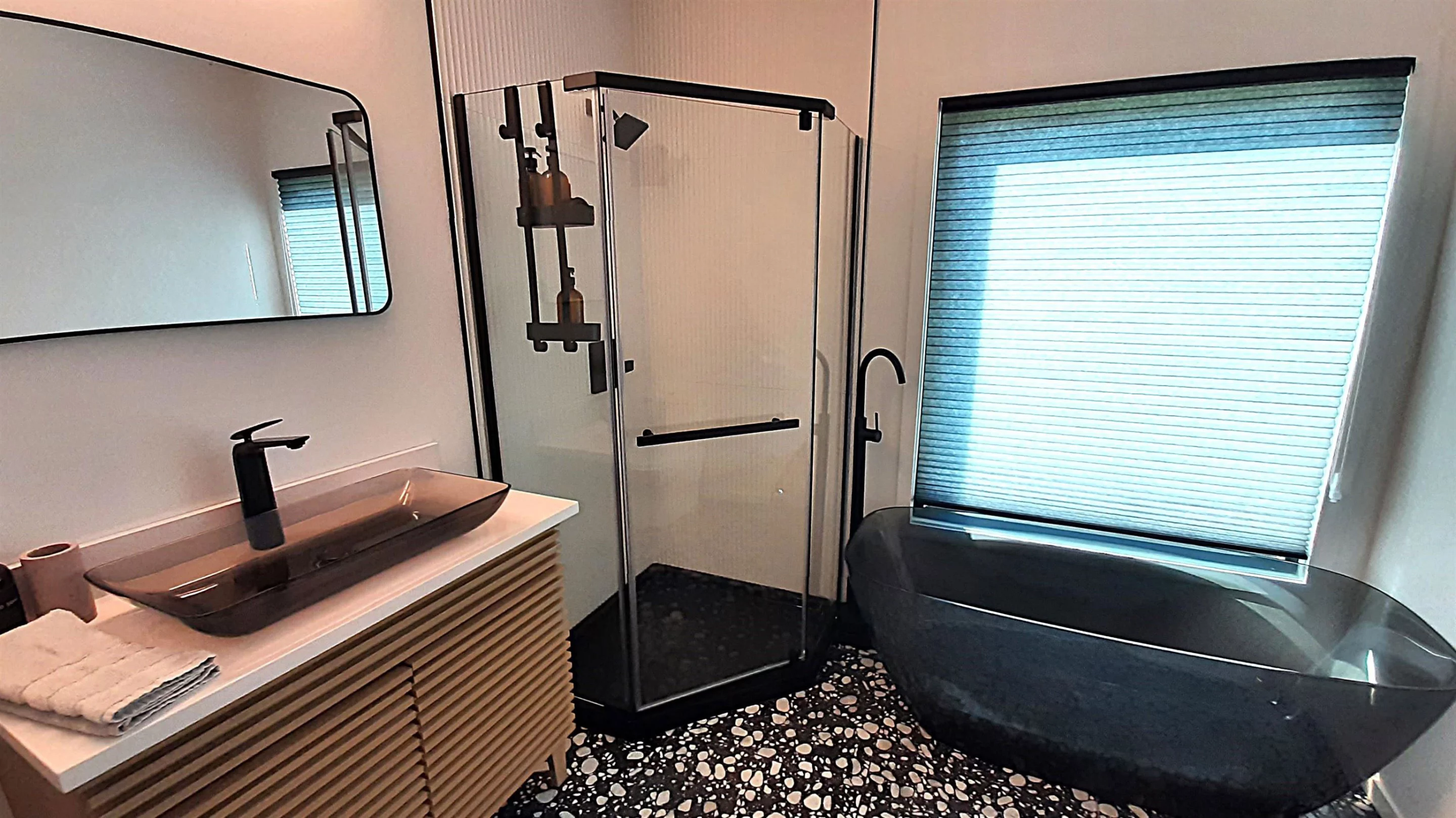 The Vermont Villa's master bathroom has a separate shower and freestanding tub, plus a vanity sink, and a flushing toilet