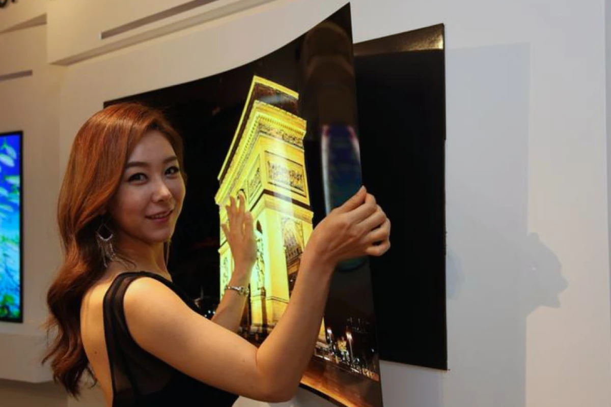 A model peels LG Display's "wallpaper OLED" panel from its magnetic mount
