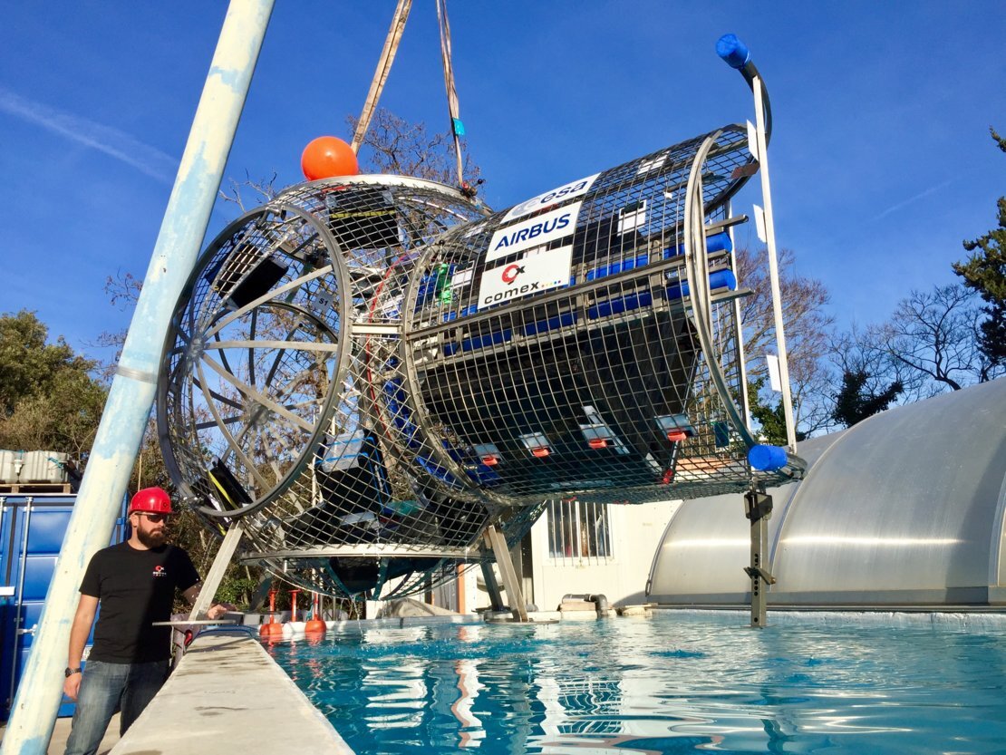 The airbus airlock being lowered into a swimming pool