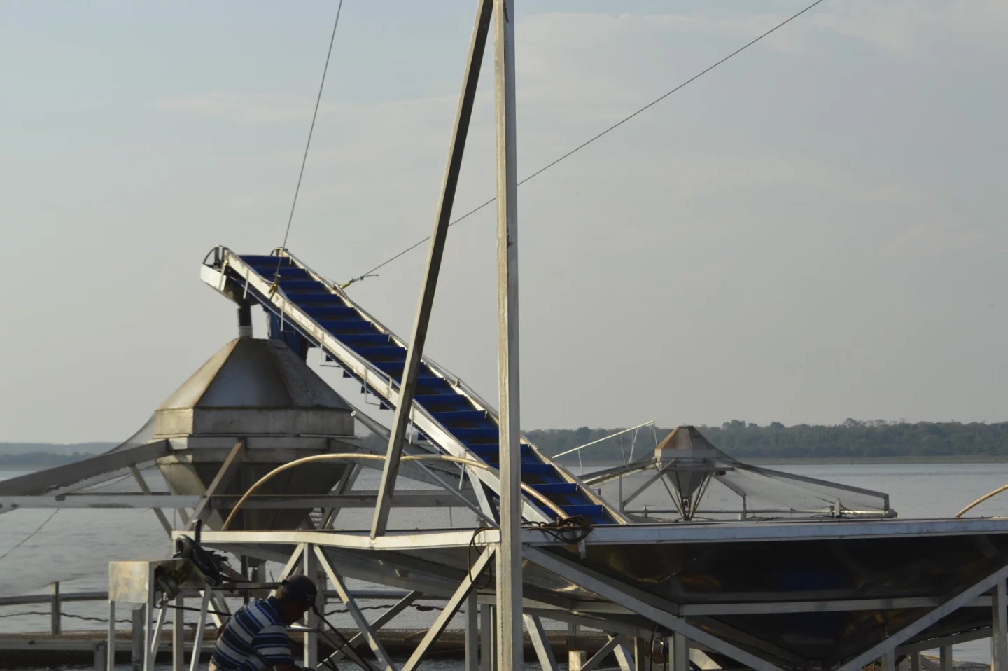 In the center of each pen is a fish-feed silo