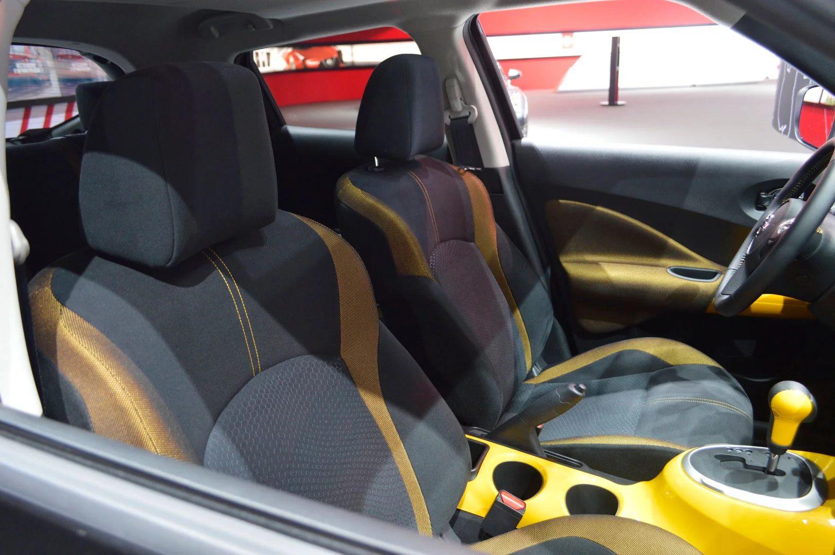 The seating is black with yellow accents and stitching