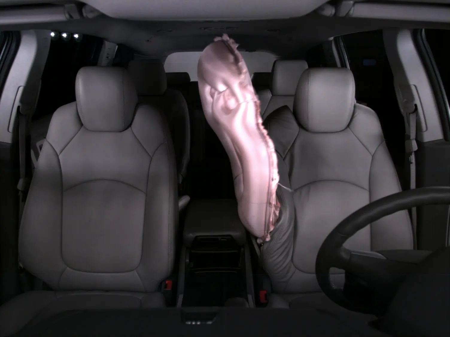 The front center airbag deploys from the right side of the driver's seat
