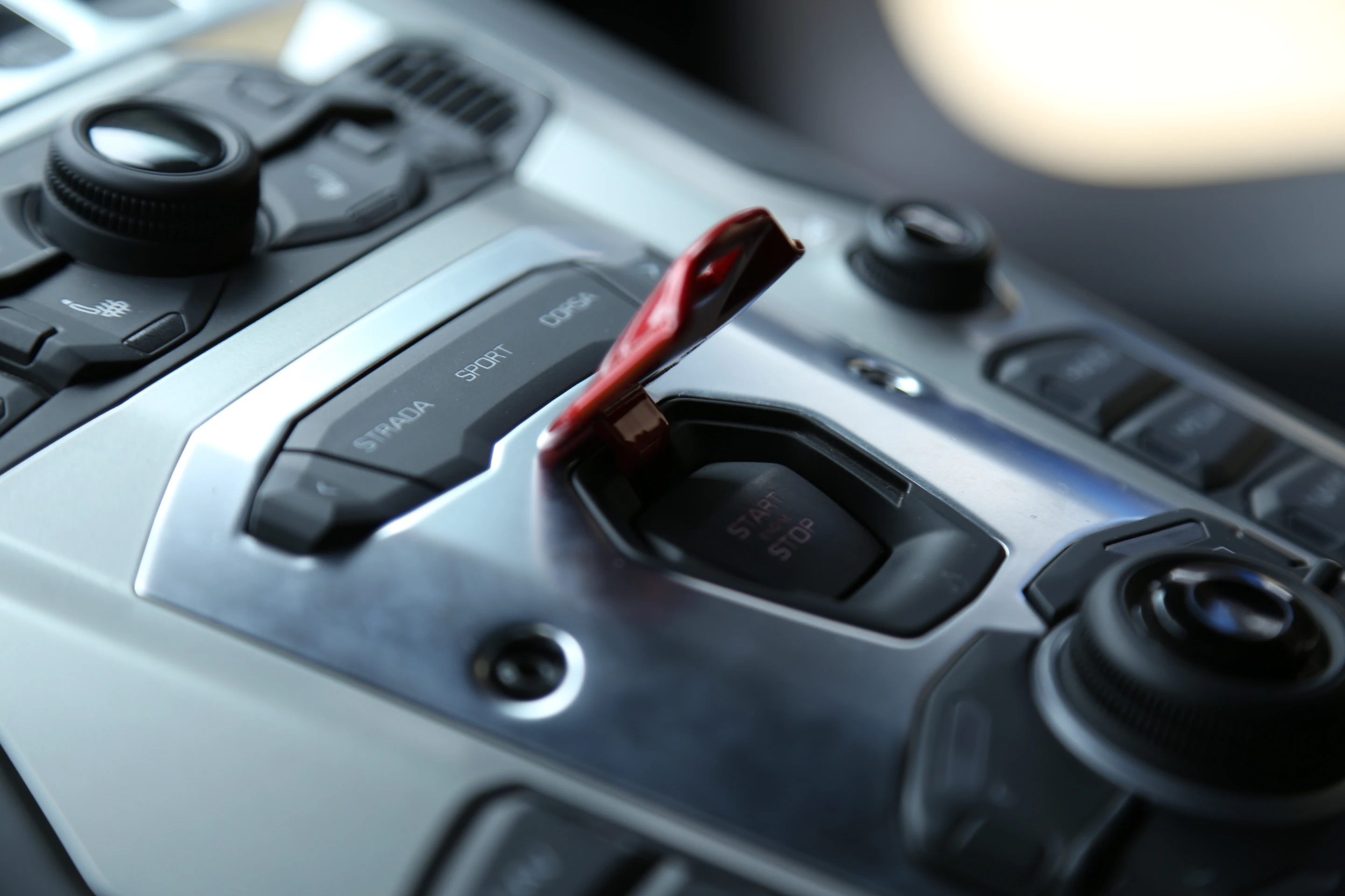Like fail-safe military launch switches, the Aventador's start button is hidden beneath a red safety cover (Photo: Angus MacKenzie/Gizmag.com)