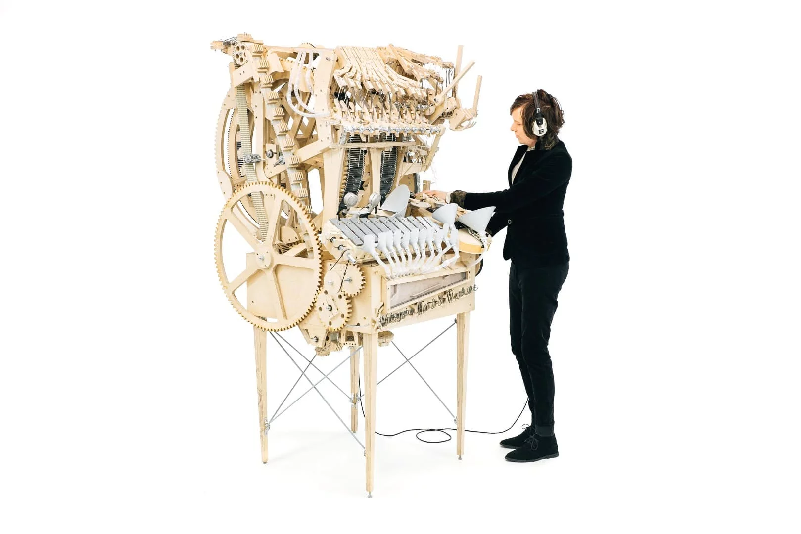 Before any music can be heard, the player needs to start turning a hand-crank that spins a flywheel which drives an intricate mix of wooden cogs, wheels and belts
