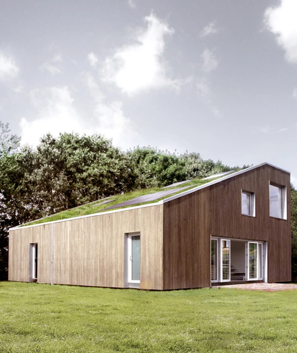 The sloping south facing roof (or north facing for the southern hemisphere), features a green landscape, solar panels and sky lights