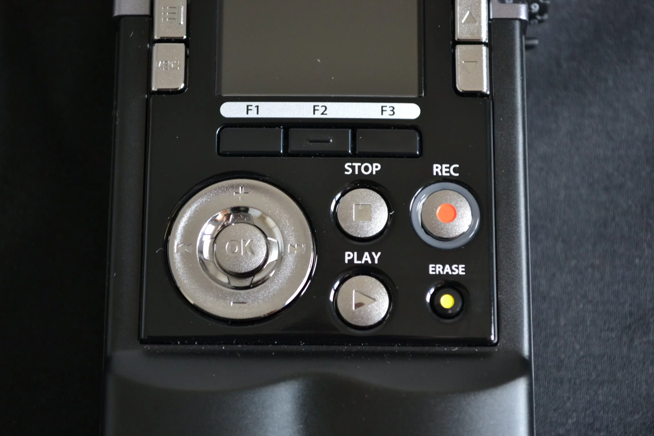 There's a jog dial bottom left and Record/Playback controls to the right, along with a file erase button