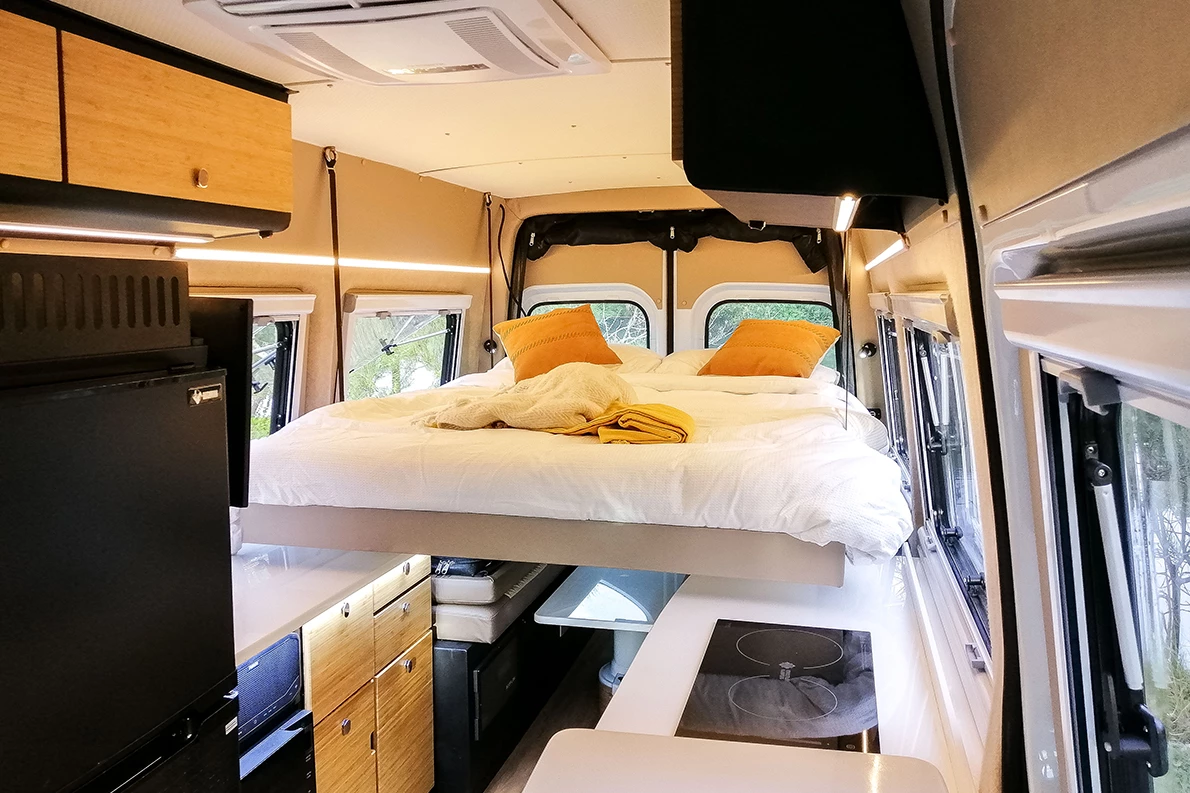 The queen-size bed lowers down at the push of a button, resting over top the dinette and counter edges