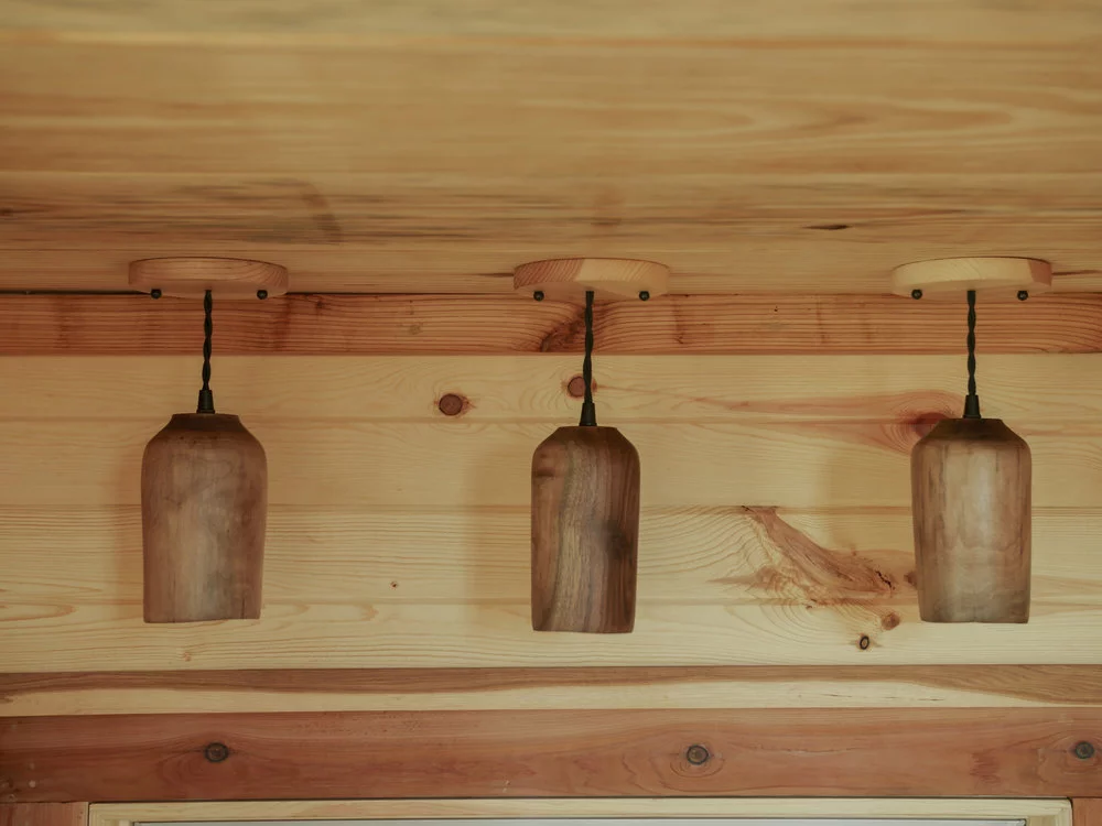 The Honey on the Rock's interior has decorative touches like wooden lamps, and exposed soldered copper water piping