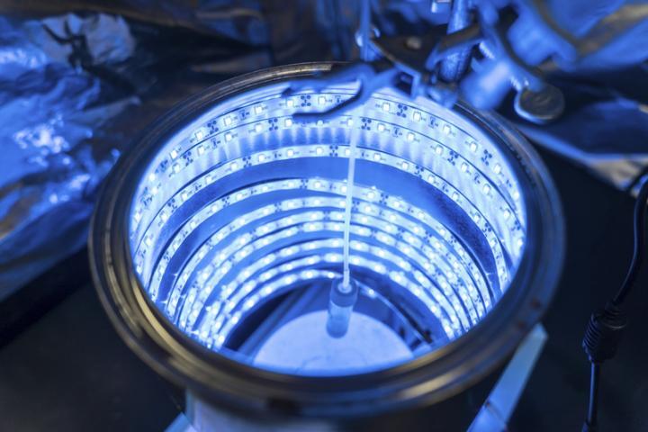 The photoreactor resembles a tanning bed, and by feeding measured amounts of carbon dioxide into the glowing cylinder, the team was able to see if the material within kicked off the chemical process