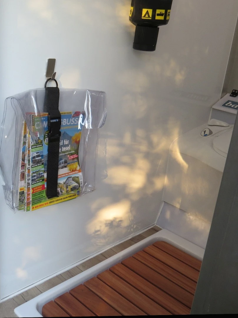 Accessories include a magazine holder and the slatted shower floor insert