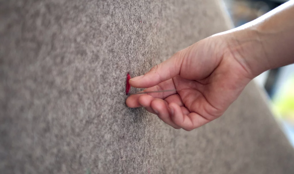 HUSH is sewn by hand with 150 meters (490 feet) of wool yarn