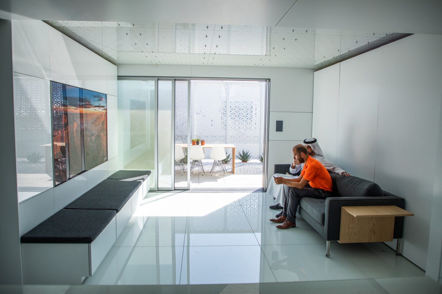 FutureHaus' living room contains a rotating TV with art on the rear side and some bench seating