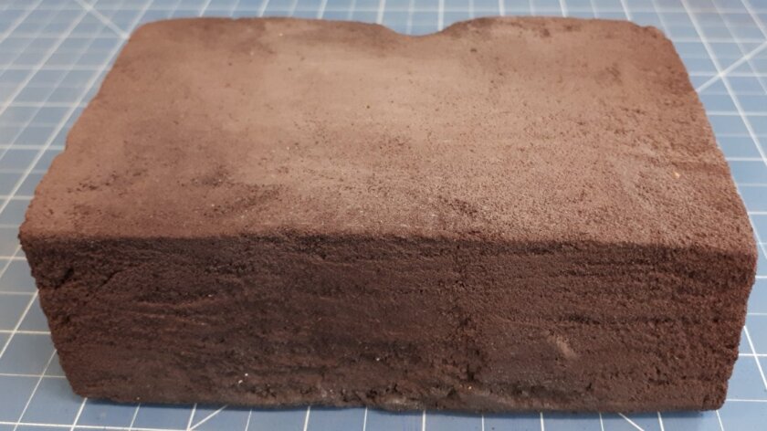 Homemade regolith brick measuring 5.5 in (14 cm) long