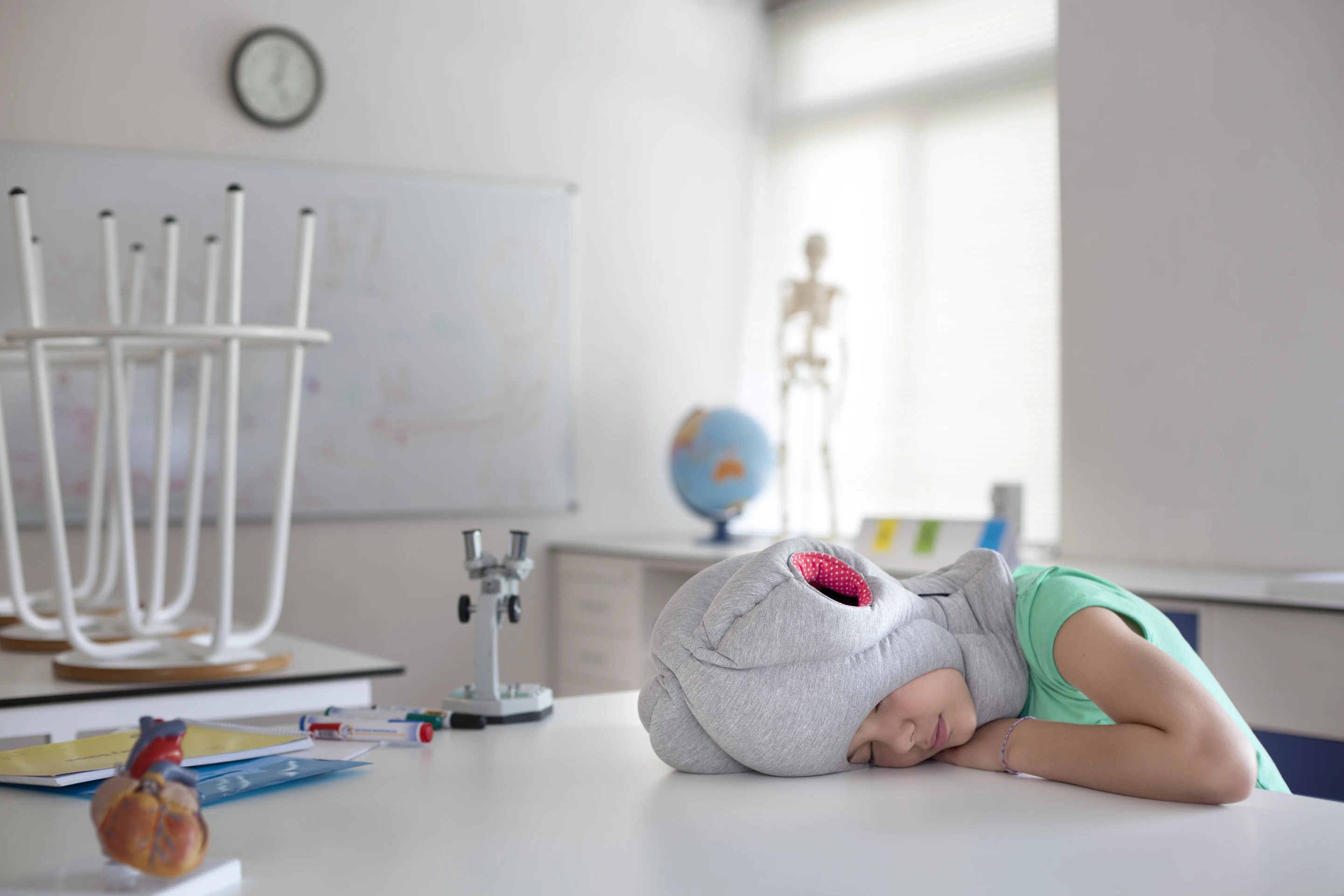 Just like the adult version, Ostrich Pillow Junior makes napping on a table more comfortable