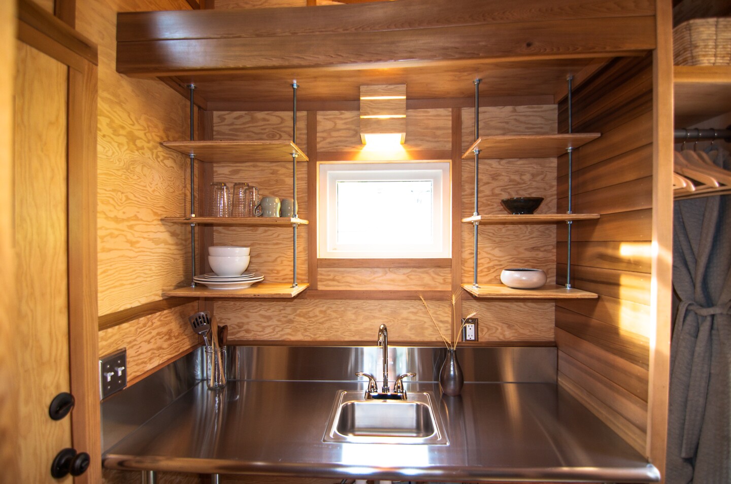 Alongside the kitchenette is a small wardrobe (Photo: Shelter Wise)