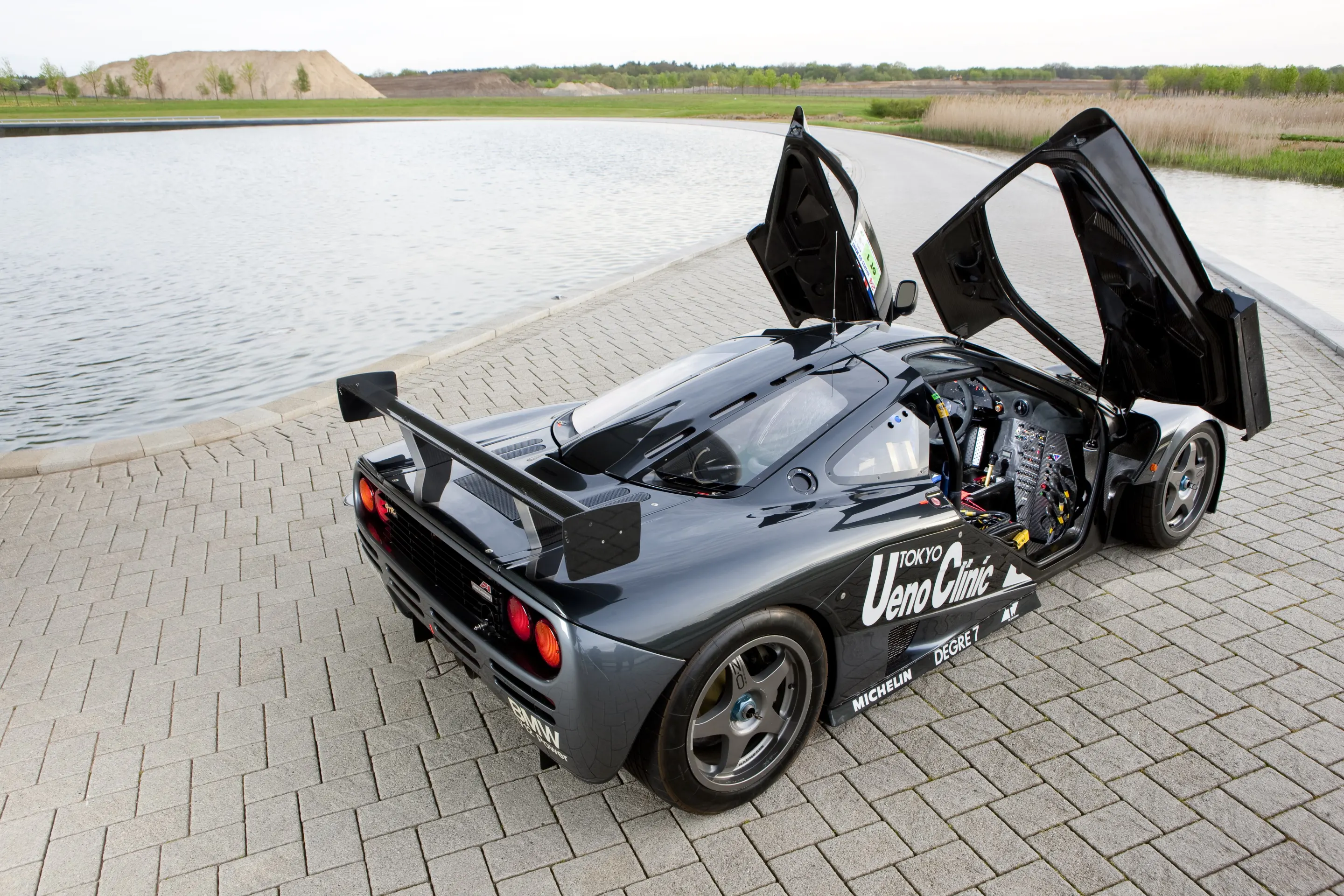 Le Mans winning F1 GTR shows center driver position, carbon fiber interior and related racing materials where right passenger seat exists