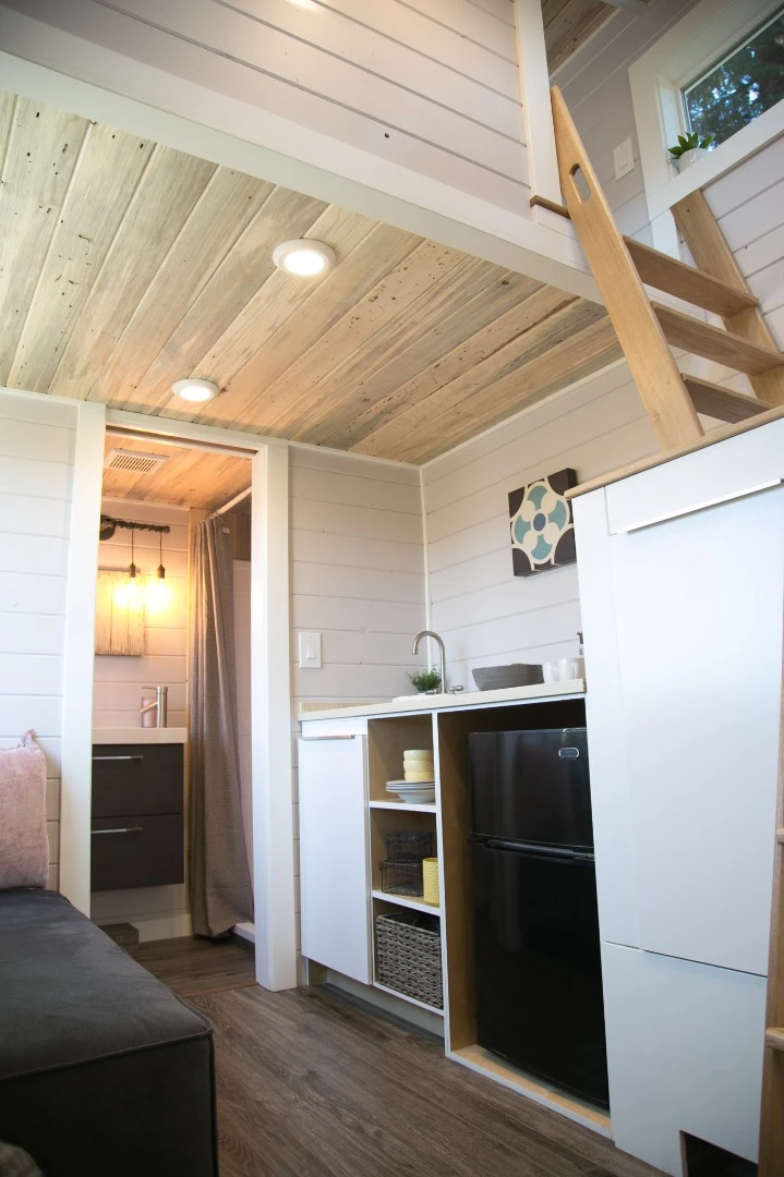 The Kentucky Donut Shop's kitchenette includes a sink, storage space, and a fridge