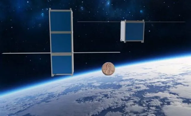 Both models of FemtoSat, compared to the size of a penny