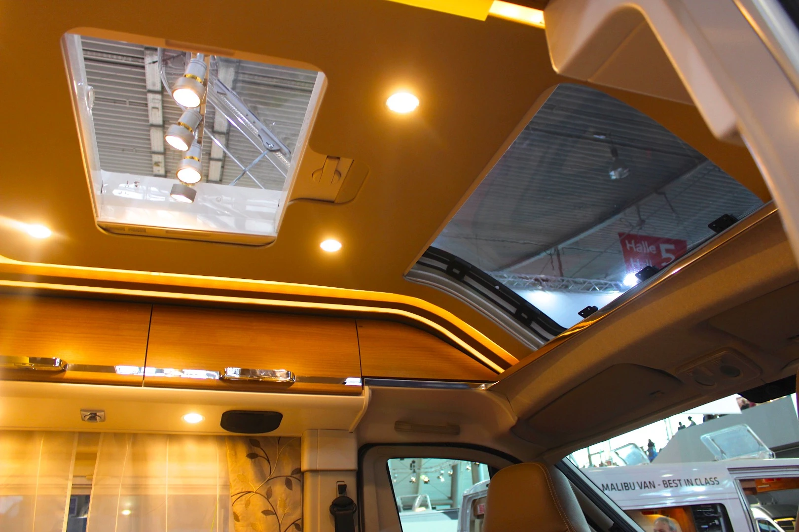 In addition to opening up the cab roof and adding in the Skyview panel, Malibu extended the cabinets forward into the cockpit, further integrating the driving and living areas of the van