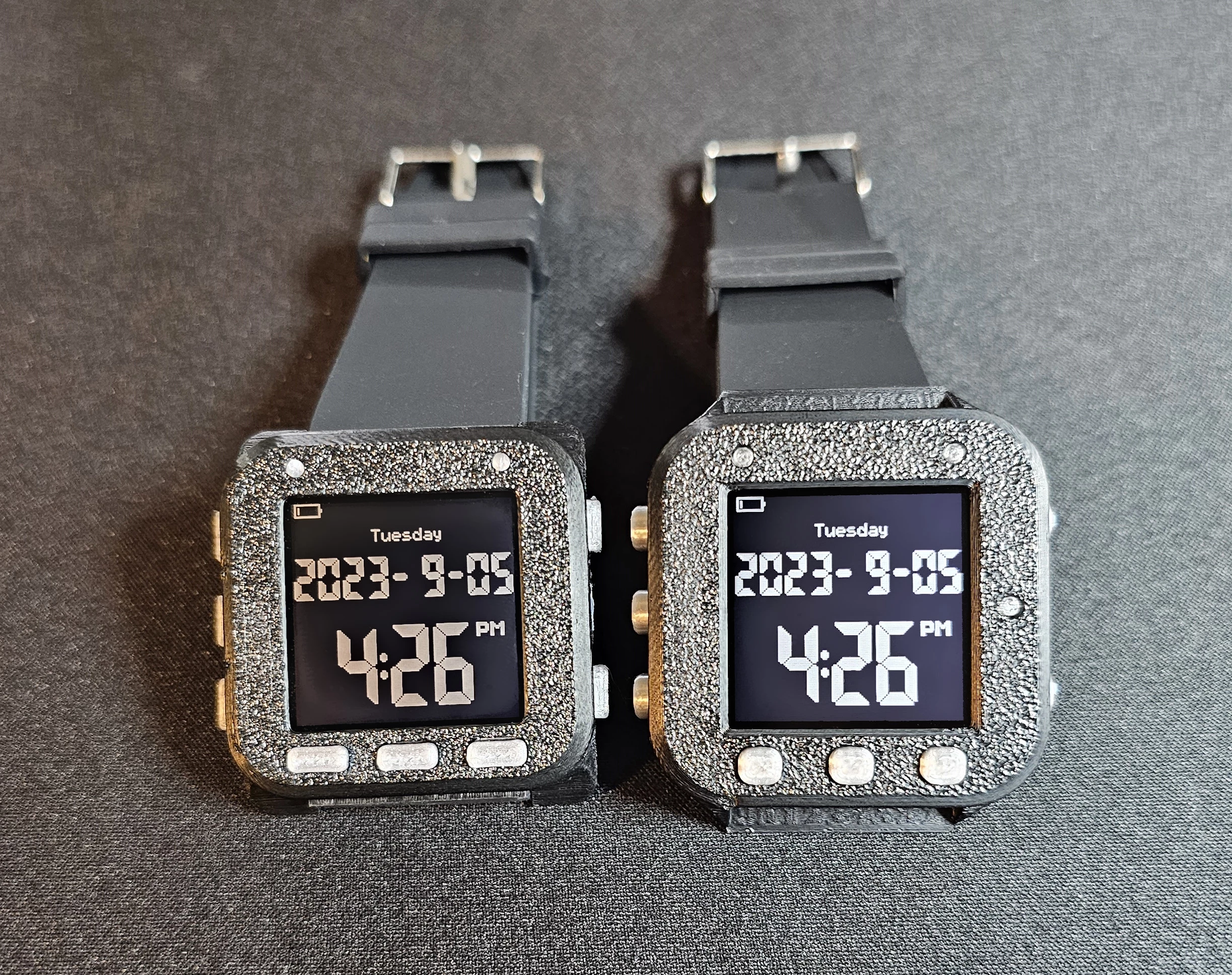 The Oscilloscope Watch wrapped in a slim (left) or standard (right) 3D-printed enclosure