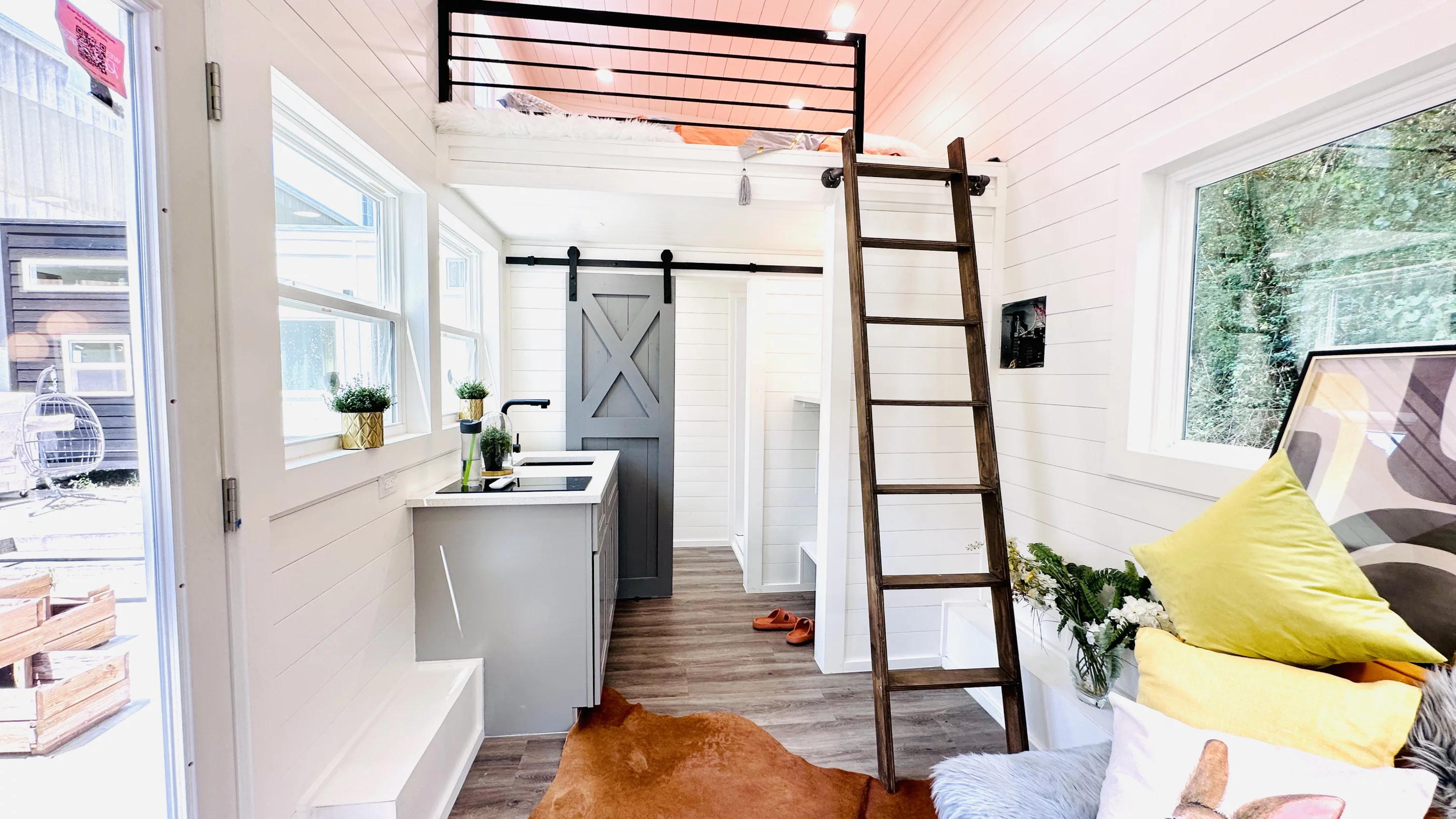 The 16' THOW With Loft's interior is mostly taken up by a combined living/kitchen area