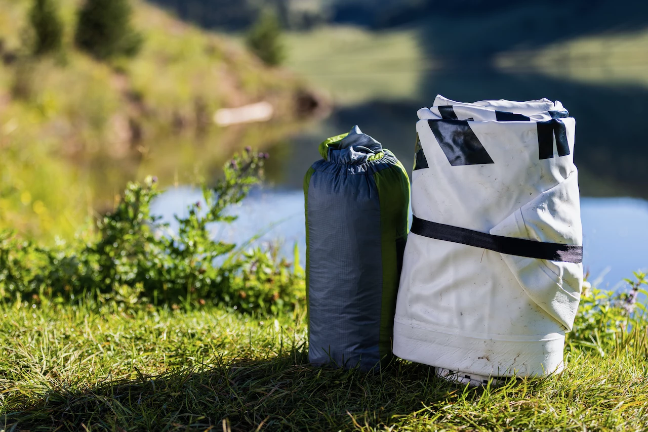 The rolled-up Chasm-Lite (right), with a stowed-away sleeping bag for scale