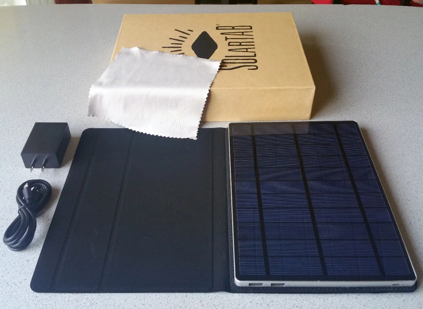 Along with the Solartab comes a wall adapter, USB charging cable, and microfiber cleaning coth