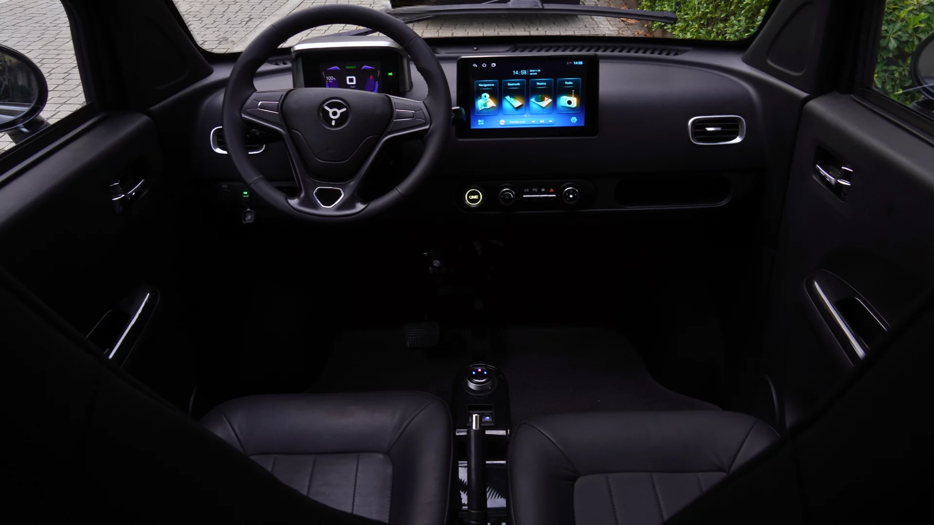 The compact interior is home to a tablet-sized interface, "high-performance" speakers, heating and aircon