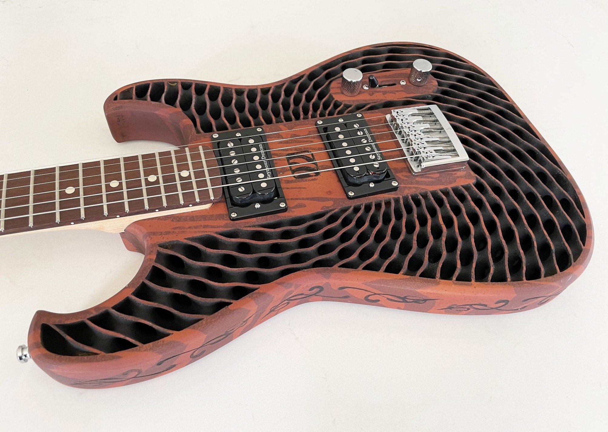 This 3Dprinted wood guitar is made from recycled sawdust