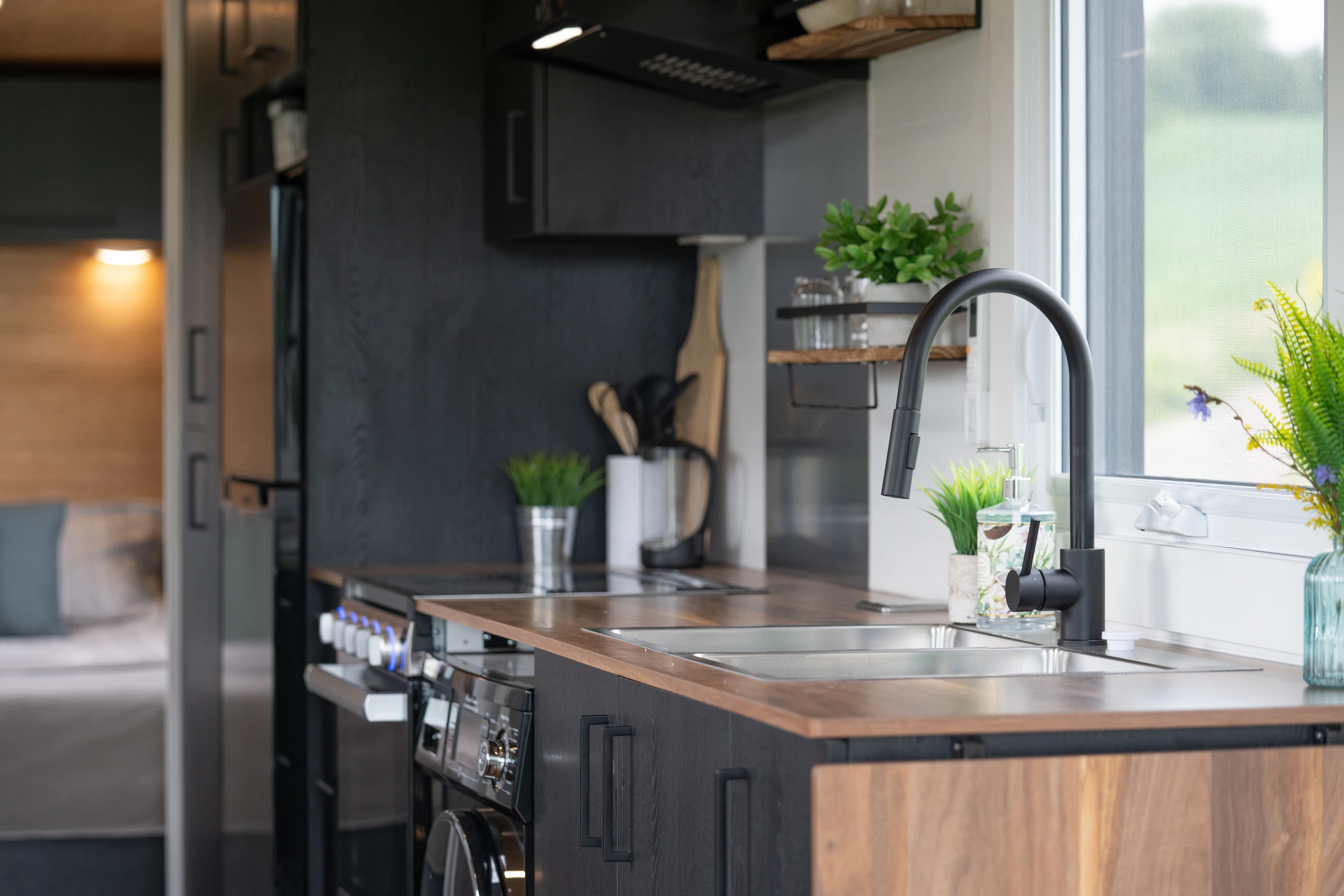 The Nomad 30's kitchen includes a double stainless steel sink and a washer/dryer