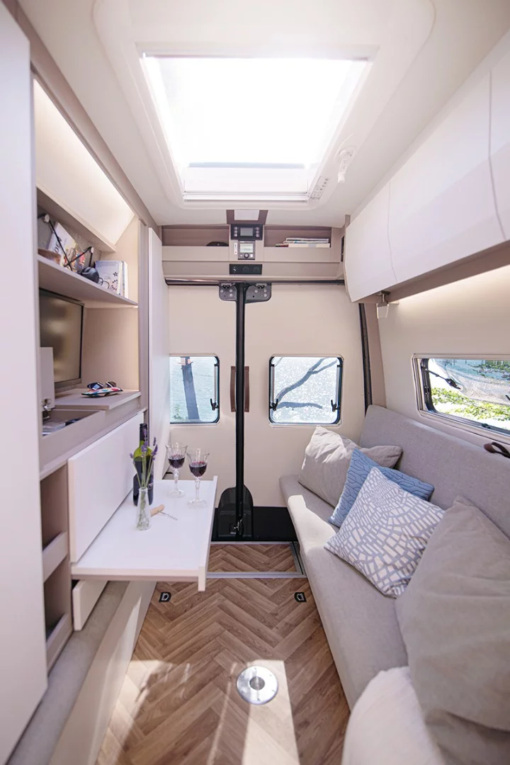 The media console to the left has a TV area, smartphone charging, bookshelf, wardrobe and more