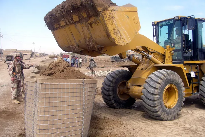 A Hesco Bastion being filled by a front loader in Iraq