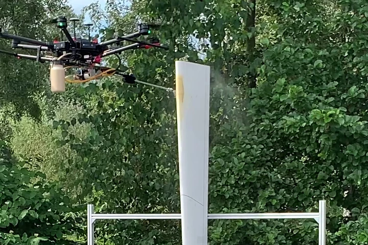 A drone performs a spray test on a section of wind turbine blade