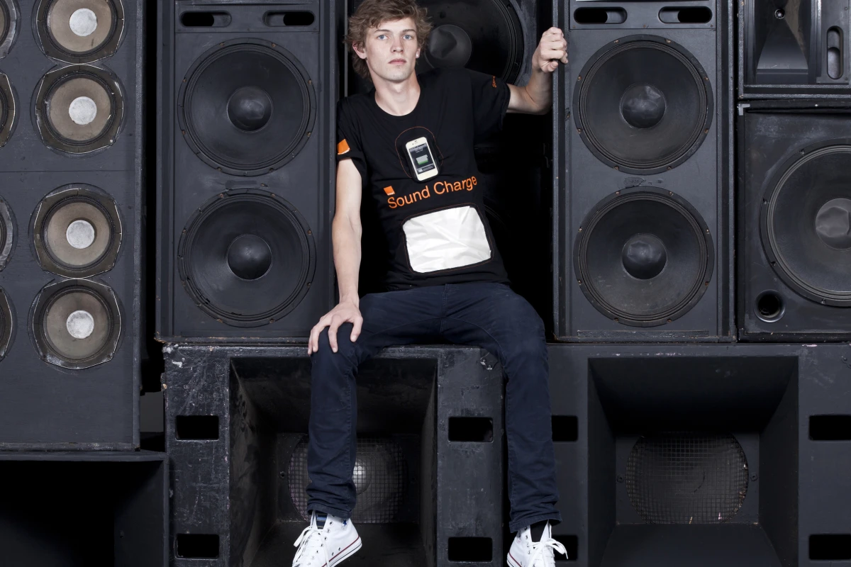 Orange and GotWind have developed a prototype mobile device charging t-shirt that uses Piezoelectric film to convert sound waves into electric charge