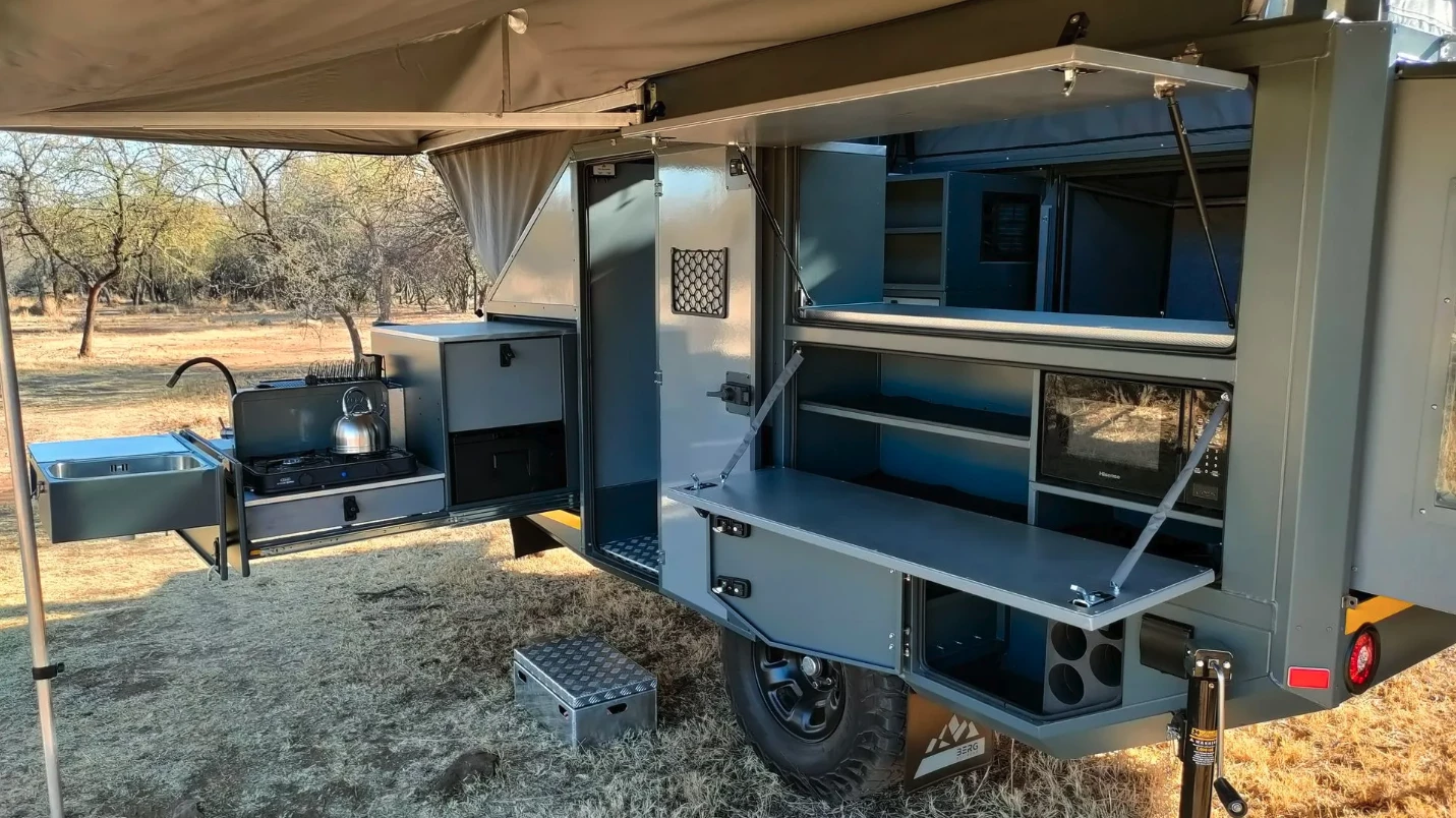 The entire left travel side of the trailer is dedicated to a large kitchen space