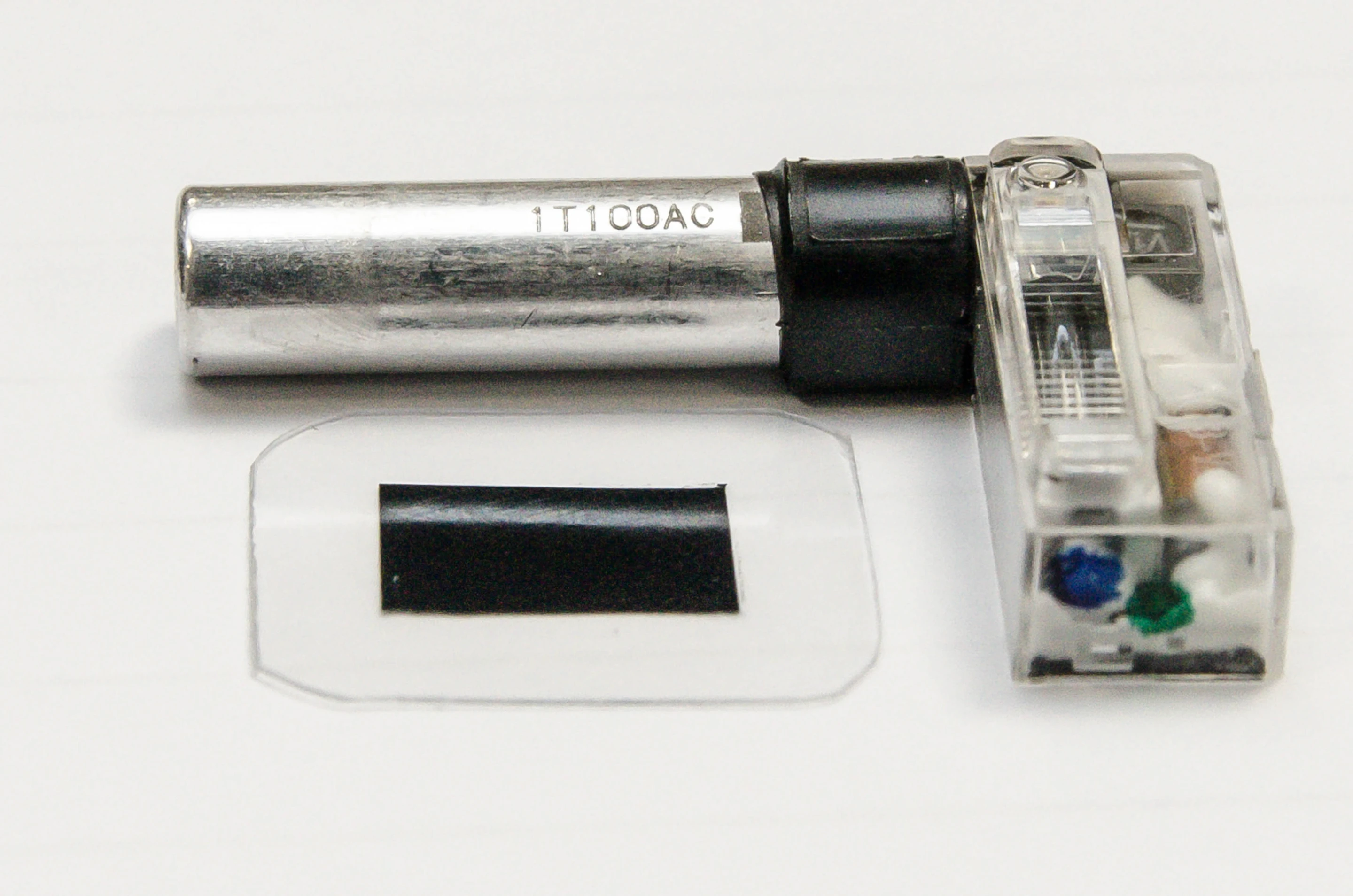 A typical smartphone flash with its existing capacitor (silver cylinder), and the new polymer capacitor material (lower left)