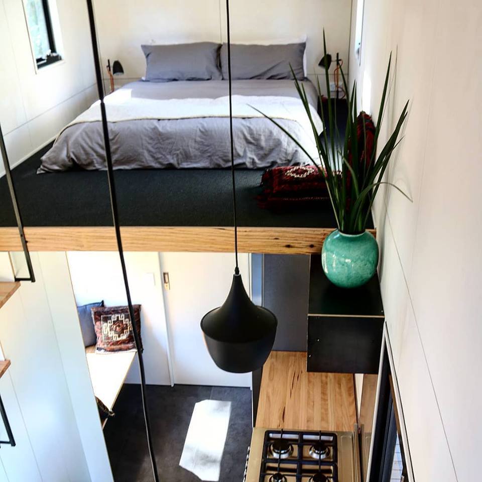 One of the Sowelo tiny house's two elevated double loft bedrooms