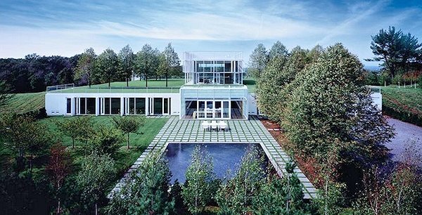 Rear view of the Taghkanic House, showing the pool, the glass pavilion, and the windows and doors for a number of the underground rooms (Photo: T. Phifer and Partners)