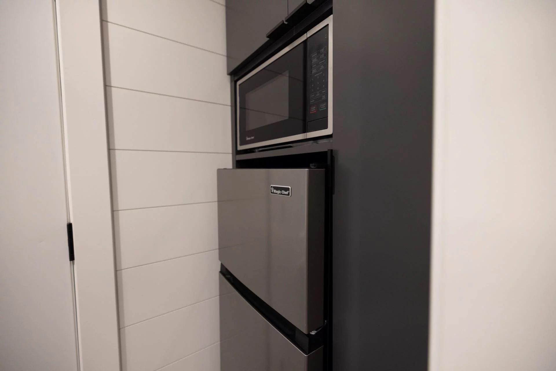 The Nook's kitchen includes a sink, cabinetry, a fridge/freezer, and a microwave