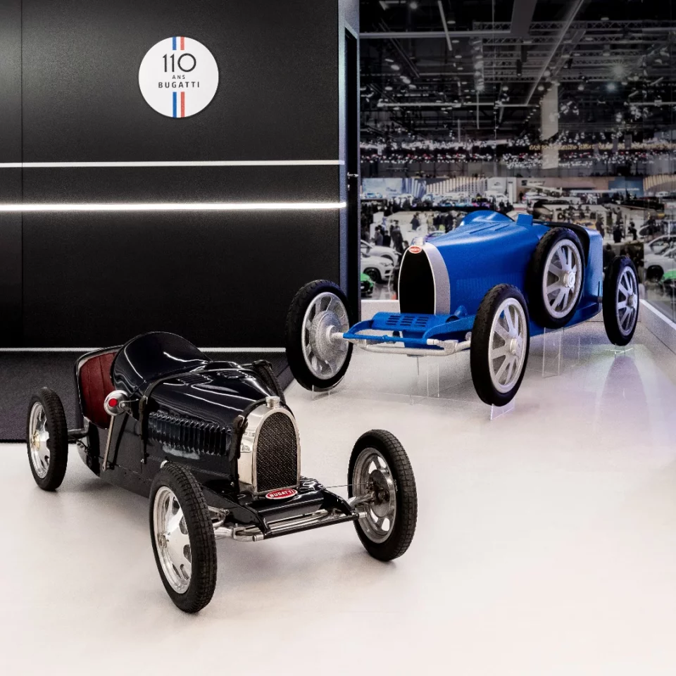 The original Bugatti Baby (foreground) was a child's toy. The new Bugatti Baby II (background) is larger and suitable for both children and adults