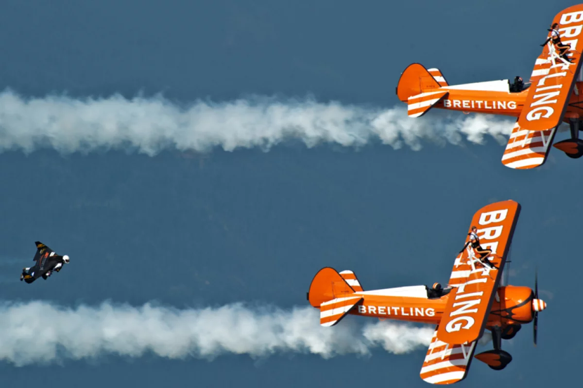 Yves "Jetman" Rossy flies in formation with the Breitling Wingwalkers